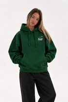 Polerón Essential Pin 2.0 Flaw - Verde botella - mujer en estudio - frente